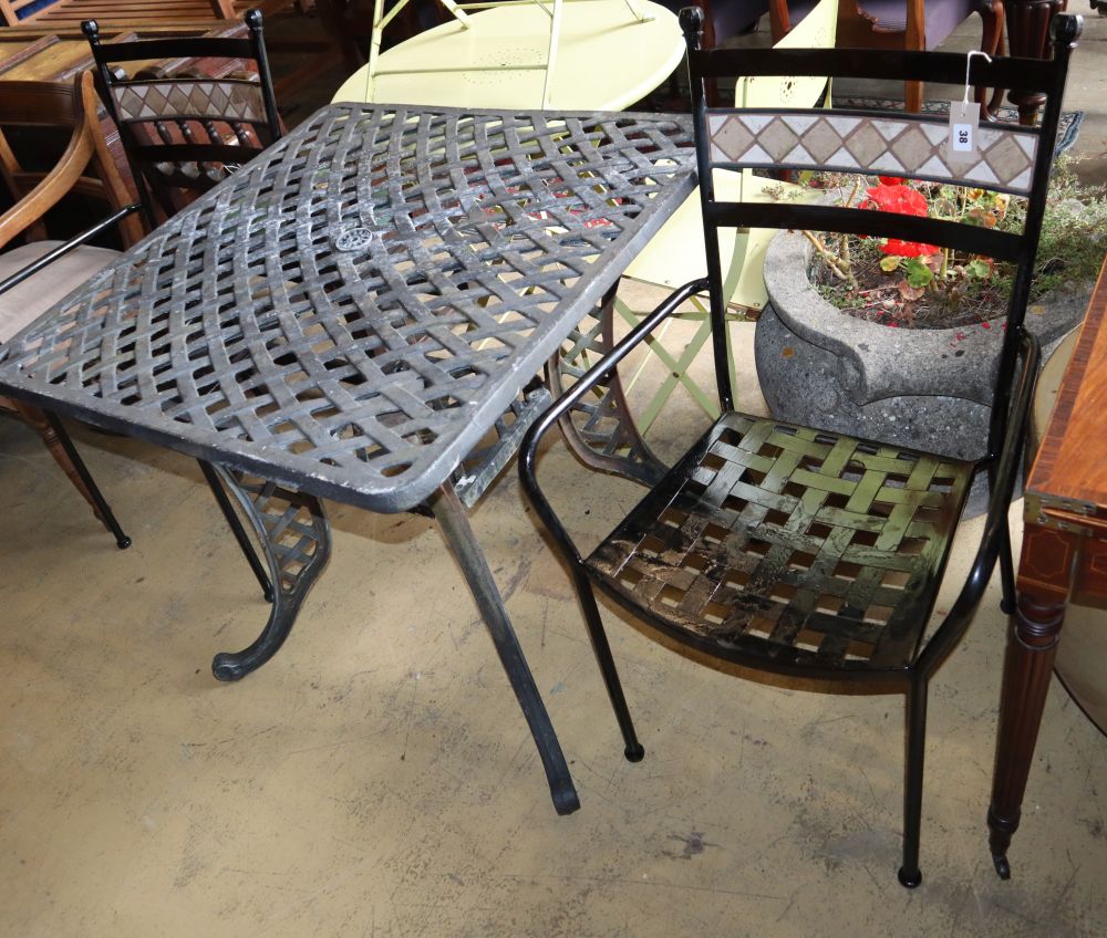 A square lattice metal garden table, W.83cm, H.76cm and two chairs