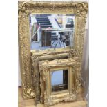 A large reproduction gilt mirror, 123 x 182cm, a similar gilt framed mirror and a gilt picture