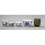 A group of Chinese cups, four ceramics, one jade and some have marksCONDITION: The smallest cup with