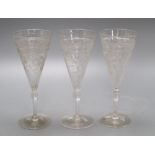 A set of thirteen etched glass flutes, height 18cm