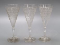 A set of thirteen etched glass flutes, height 18cm