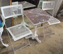 A cast iron garden table with marble top, W.53cm, H.70cm and two metal folding chairs