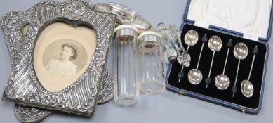 Two early 20th century silver photo frames, a cased set of 6 silver coffee spoons, a silver