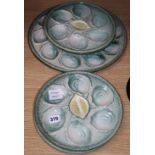 A set of four pottery oyster dishes, and a platter, the platter diameter 37cm