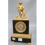 A 19th century French ormolu mounted black marble eight day mantel clock, surmounted by a figure