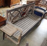 A weathered teak garden bench with detachable end drink holders, W.182cm, D.52cm, H.92cm