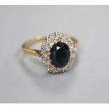 An 18ct gold diamond and sapphire ring, finger size N