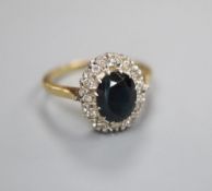 An 18ct gold diamond and sapphire ring, finger size N