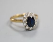 A diamond and sapphire ring, stamped '18ct & Plat', finger size L/M