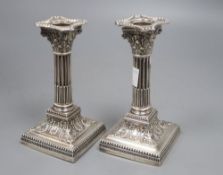 A pair of Edwardian repousse silver corinthian column candlesticks, James Dixon & Sons, Sheffield,