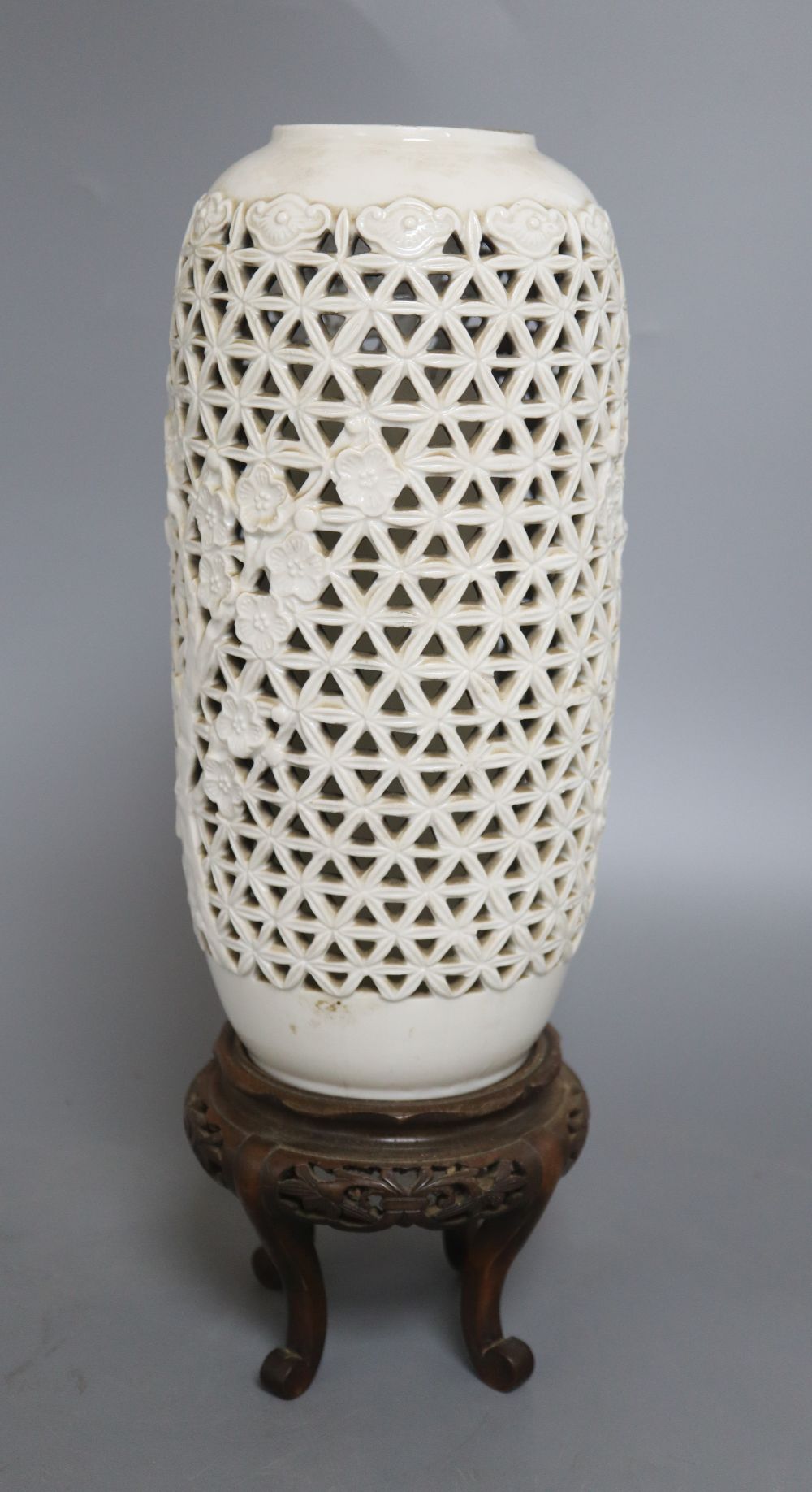 A Chinese pierced blanc de chine lantern, hardwood stand, overall height 36.5cm