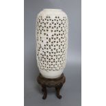 A Chinese pierced blanc de chine lantern, hardwood stand, overall height 36.5cm