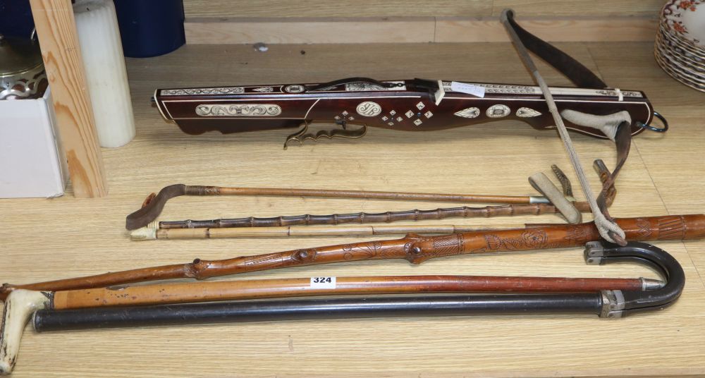 A European bone inlaid crossbow, two walking canes and three riding crops