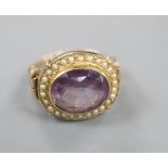 A 19th century style 14k, oval cut amethyst and seed pearl set dress ring, size O, gross 6.1 grams.