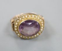 A 19th century style 14k, oval cut amethyst and seed pearl set dress ring, size O, gross 6.1 grams.