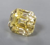 An unmounted emerald cut yellow gemstone, possibly cubic zirconia, weighing approximately 29.00ct.