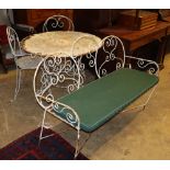 A circular metal garden table, a pair of matching chairs and a bench seat, bench W.130cm, D.56cm,