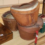 Three silk top hats and leather hat boxesCONDITION: All leather top hat boxes are damaged, the