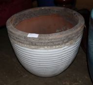 A large white glazed ribbed garden planter, 47cm diameter