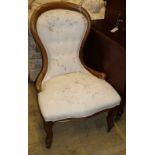 A Victorian faded mahogany spoon back nursing chair