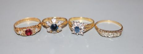 Four assorted 18ct gold and gem set dress rings, including Edwardian red stone(chipped) and