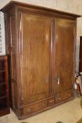 An 18th century Normandy oak two door armoire with brass escutcheons and buttressed hinges, W.178cm,