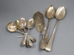 Mixed silver flatware, including two George III basting spoons, a George III fish slice, two 19th