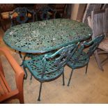 A painted metal garden table, W.136cm, D.76cm, H.68cm, bench seat and two chairs