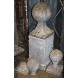 Three reconstituted stone garden ball finials, (one on pedestal) H.104cm