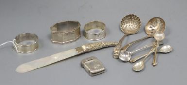 Three silver napkin rings, a silver vesta case, a silver handled letter opener and items of small