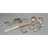 Three silver napkin rings, a silver vesta case, a silver handled letter opener and items of small