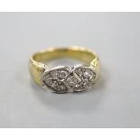A modern 750 and eleven stone diamond set 'twin hearts' dress ring, size N, gross 5.1 grams.