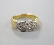 A modern 750 and eleven stone diamond set 'twin hearts' dress ring, size N, gross 5.1 grams.