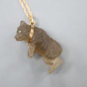 A carved quartz or glass bear pendant, on a yellow metal chain, chain 34cm.CONDITION: 2 small