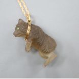 A carved quartz or glass bear pendant, on a yellow metal chain, chain 34cm.CONDITION: 2 small