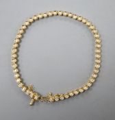 An 18ct gold and diamond set line bracelet, with safety chain, approx. 18cm, gross 12.8 grams.