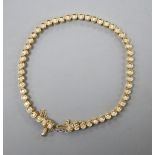 An 18ct gold and diamond set line bracelet, with safety chain, approx. 18cm, gross 12.8 grams.