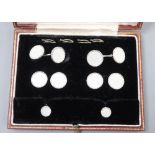 A cased 9ct white gold and mother-of-pearl eight piece dress stud set, in Garrard & Co box, gross