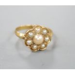 A yellow metal and seven stone split pearl cluster ring, size P/Q, gross 3.8 gram.