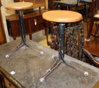 A pair of mid century design oak and wrought iron adjustable typists' stools, seat diameter 30cm