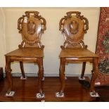 A pair of Victorian oak hall chairs