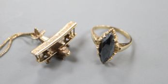 A modern 10kt and hematite navette shaped ring, size O, gross 3.2 grams and a 9ct gold bi-plane