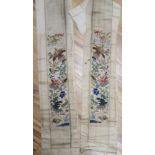 A pair of 19th century Chinese cream silk satin sleeve bands, embroidered with large ornate