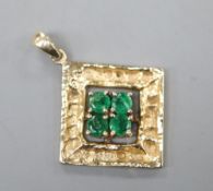 A modern 14k and four stone emerald set diamond shaped pendant, 20mm, gross 2.1 grams.CONDITION: Two