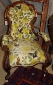 A Victorian walnut spoonback open armchair