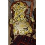 A Victorian walnut spoonback open armchair