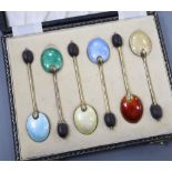 A cased set of six silver gilt and polychrome enamel bean end coffee spoons, William Suckling Ltd,