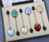 A cased set of six silver gilt and polychrome enamel bean end coffee spoons, William Suckling Ltd,