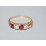 An early 20th century yellow metal, two(ex three) stone ruby and two stone diamond half hoop ring,