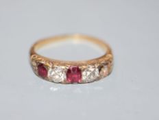 An early 20th century yellow metal, two(ex three) stone ruby and two stone diamond half hoop ring,